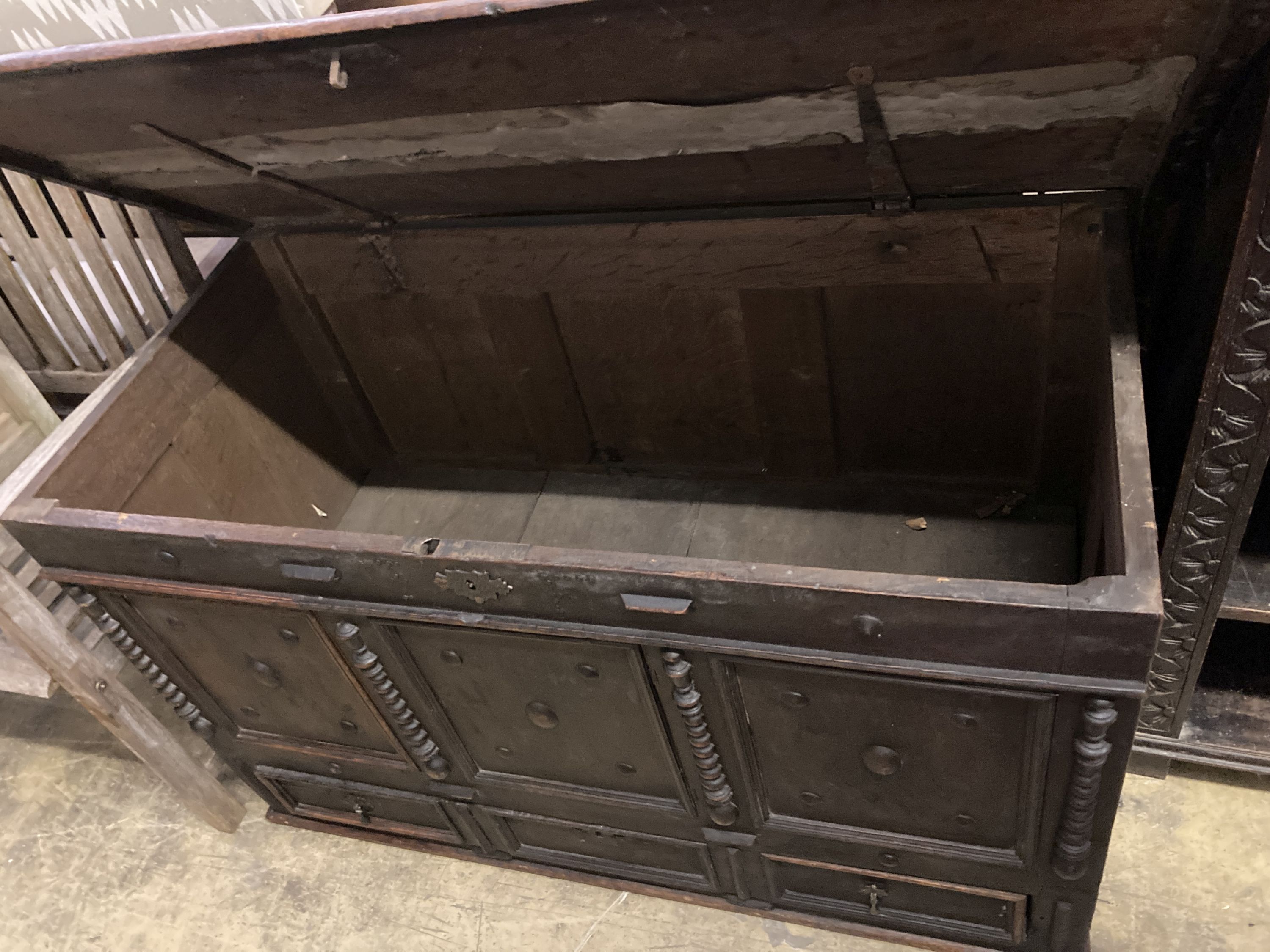 An 18th century panelled oak mule chest, length 117cm, depth 56cm, height 70cm